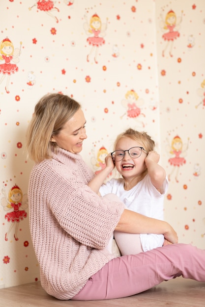 Mother and her daughter playing and hugging