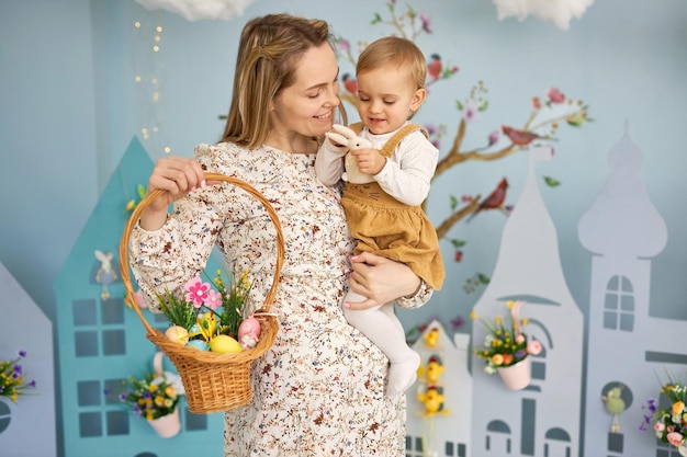 Mother and her daughter with painting eggs