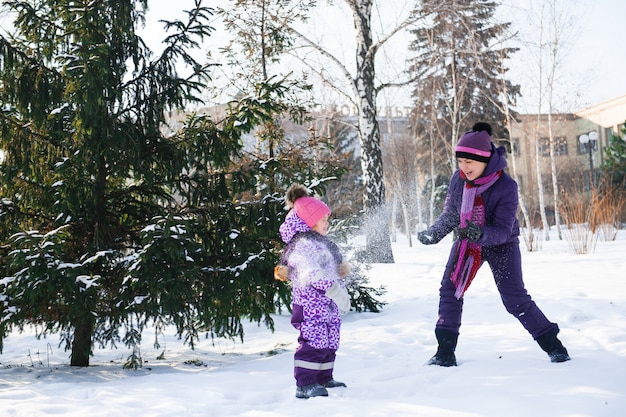 Mother and her little daughter enjoying beautiful winter day