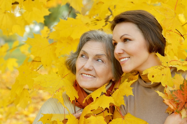 Mother and her nice daughter in autumn park