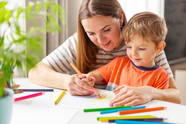 Mother and her son drawing together