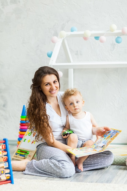 Mother and her son play together indoor