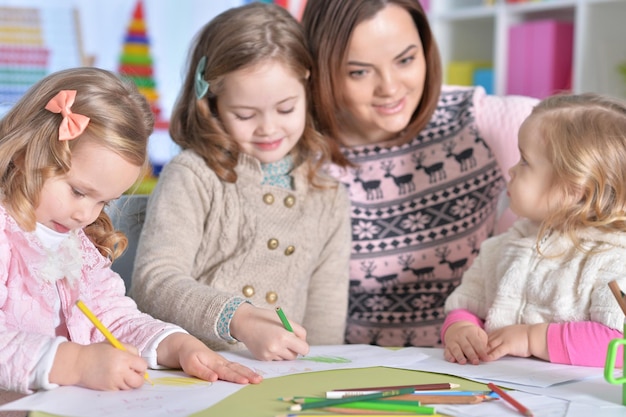 Mother and her three daughters drawing together