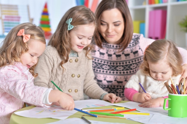 Mother and her three daughters drawing together