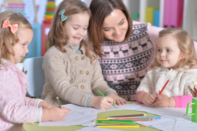 Mother and her three daughters drawing together