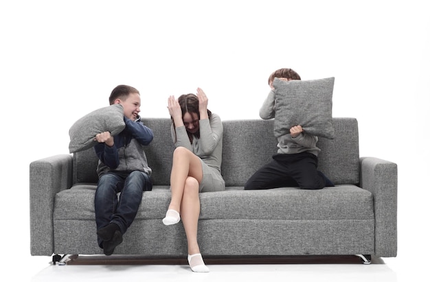 Mother and her two sons are having a pillow fight