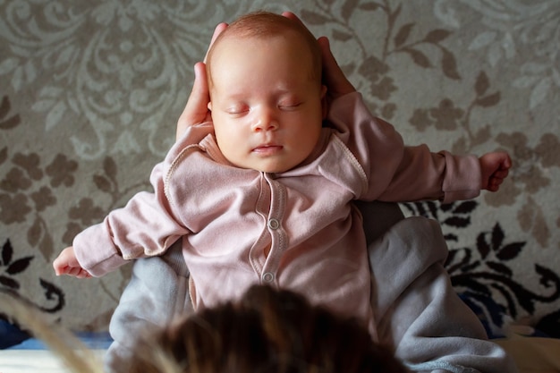 Mother holding baby in hands top view