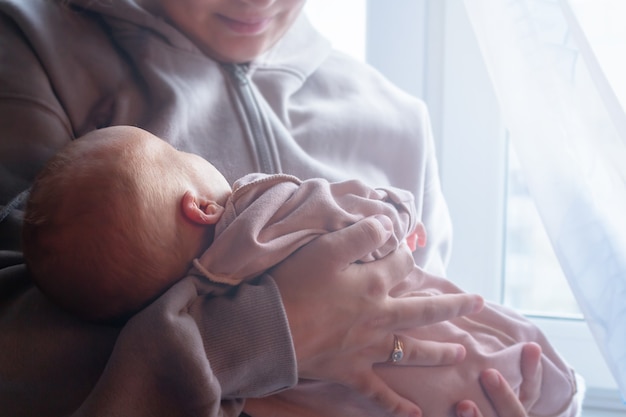 Mother holding baby in hands top view