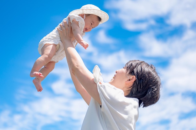 A mother holding her baby in the air