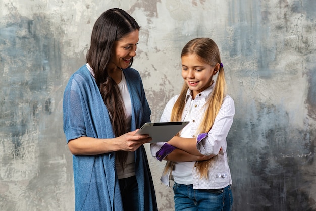 Mother holding ipad and looking for her daughter