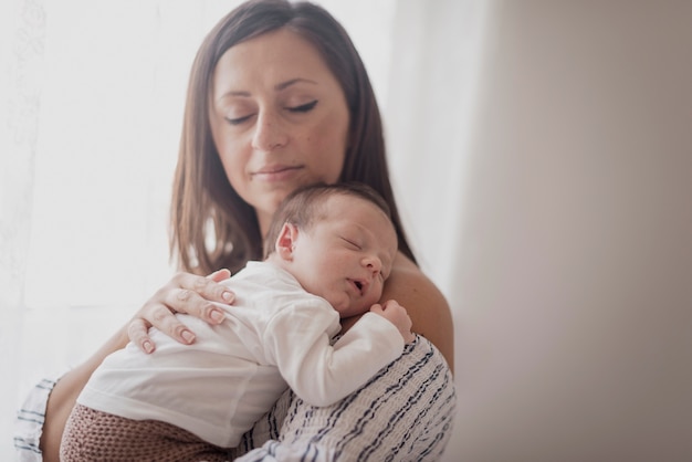 Mother holding little boy sleeping