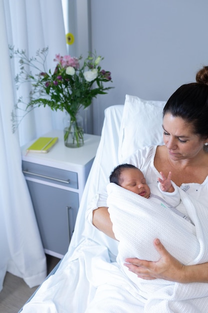 Mother holding newborn baby in hospital