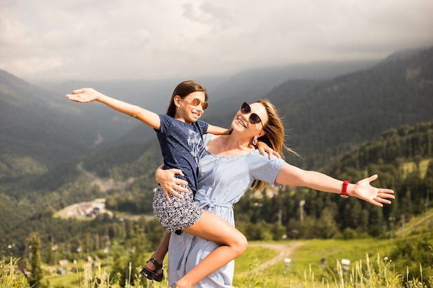 Mother hugging daughter. Holiday trip concept