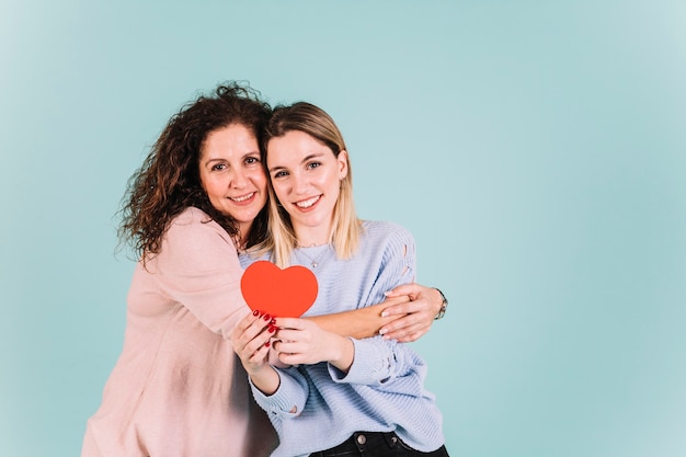 Mother hugging daughter with heart