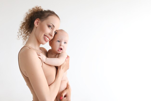 Mother and little boy son closeup portrait happy faces on background mom