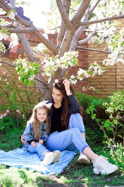 Mother and little daughter playing together in the park.