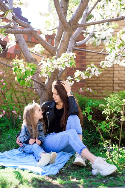 Mother and little daughter playing together in the park