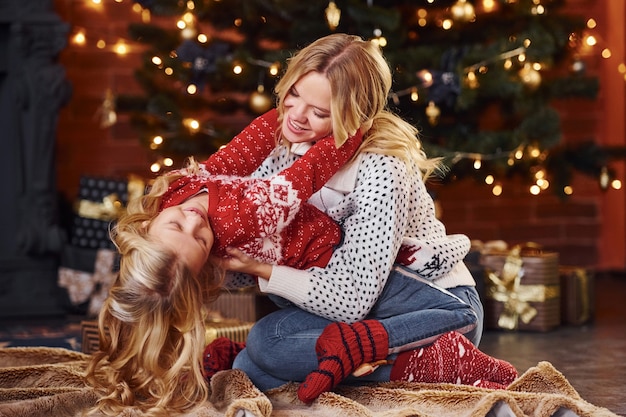 Mother and little girl having fun and celebrating christmas holidays.