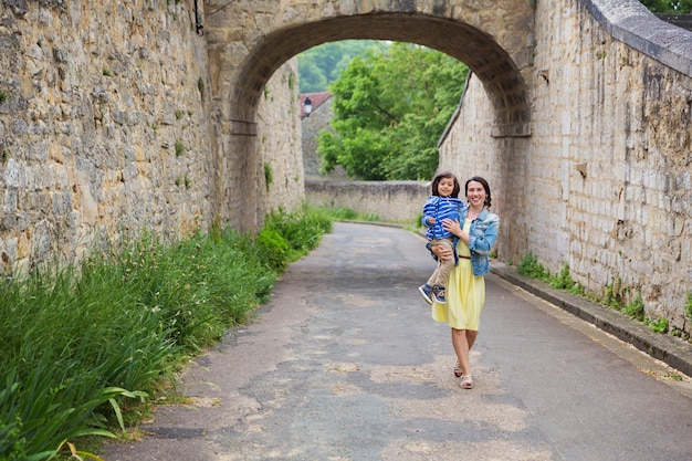 Mother and little handsome baby boy playing outdoor in old town