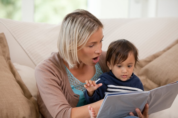 Mother looking at a book with her son