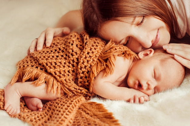 Mother lying on top of a baby