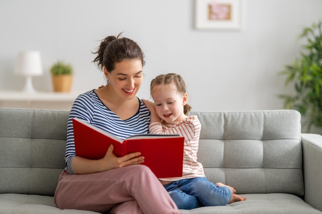 Photo mother reading a book to daughter