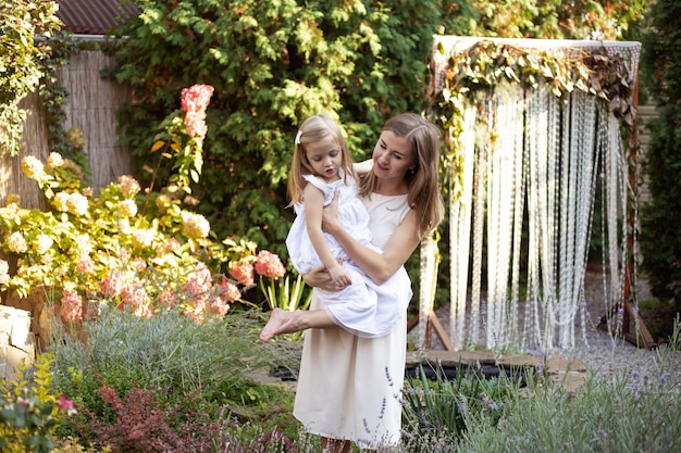 Mother's day, mother and daughter having fun in garden