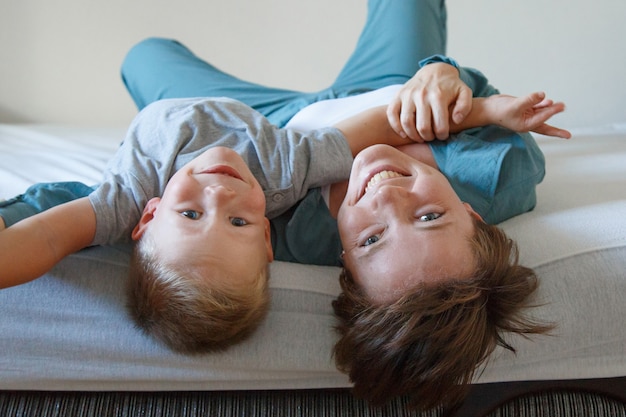 Mother's day. mother's love. A happy woman and a boy in blue cloth embrace. . copy space. Game with son