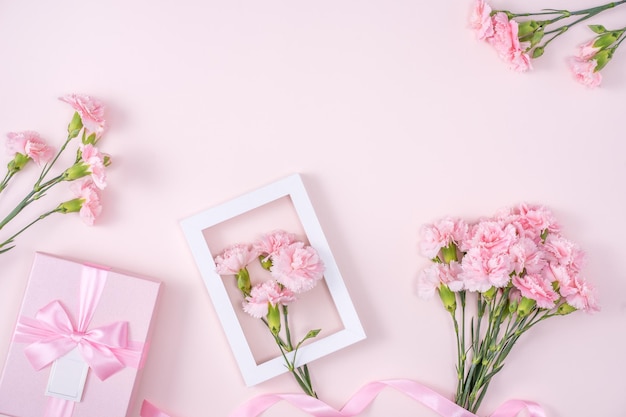 Mother's Day Valentine's Day background design concept beautiful pink carnation flower bouquet on pastel pink table top view flat lay copy space