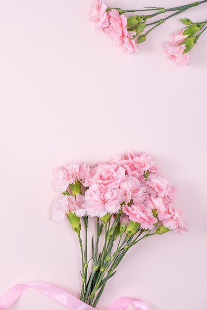 Mother's Day Valentine's Day background design concept beautiful pink carnation flower bouquet on pastel pink table top view flat lay copy space