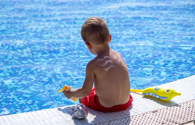 Mother smears the child with sunscreen