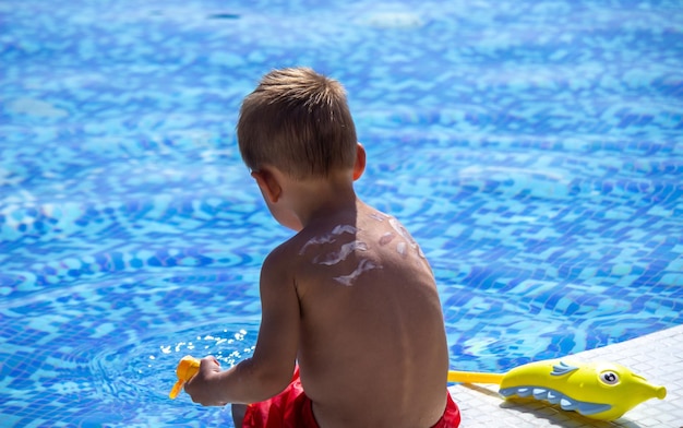 Mother smears the child with sunscreen