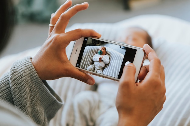 Mother snapping a photo of her newborn