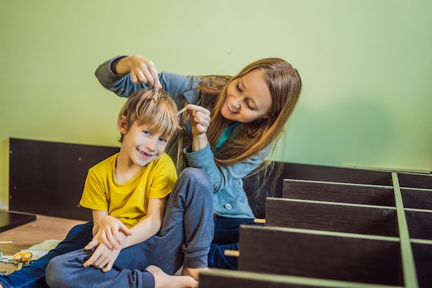 Mother and son assembling furniture Boy helping his mom at home Happy Family concept