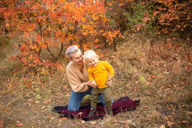 Mother and son in autumn background Thanksgiving holiday season