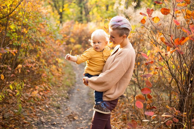 Mother and son in the autumn background Thanksgiving holiday season