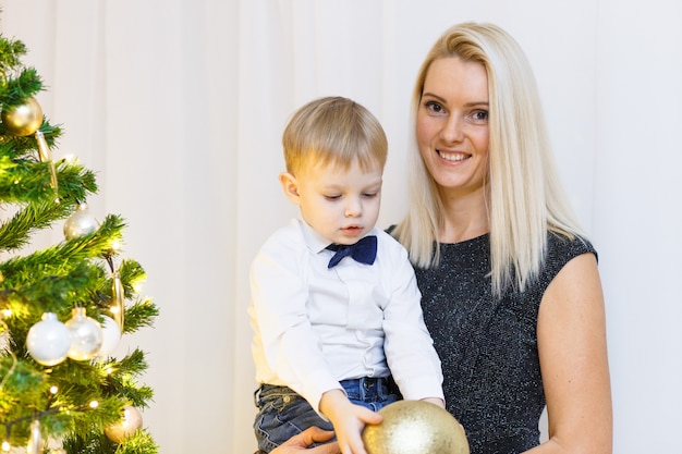 Mother and son decorating christmas tree