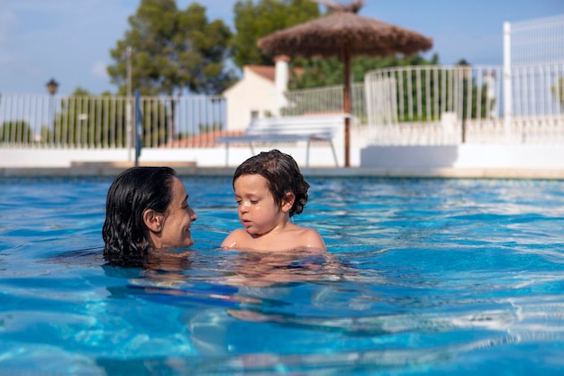 Mother and son enjoying the pool