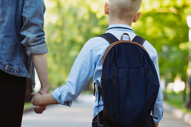 Mother and son going to school holding hands