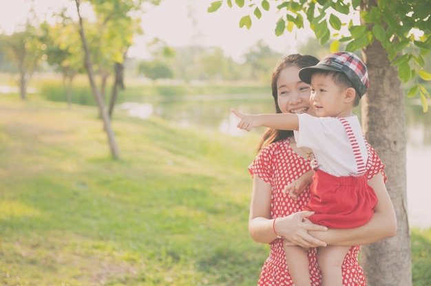 A mother and son playing outdoors at evening