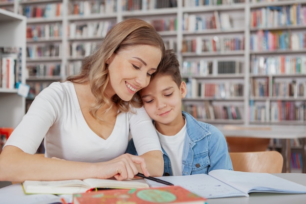 Mother and son reading at the library