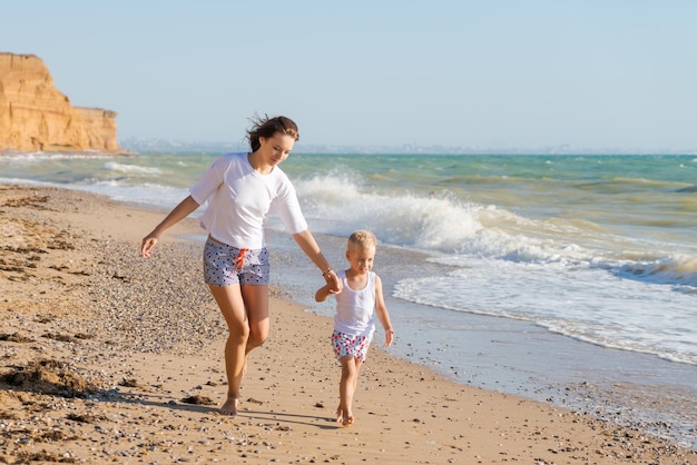 Mother and son walking on the beach