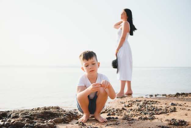 Mother and son walking by the beach