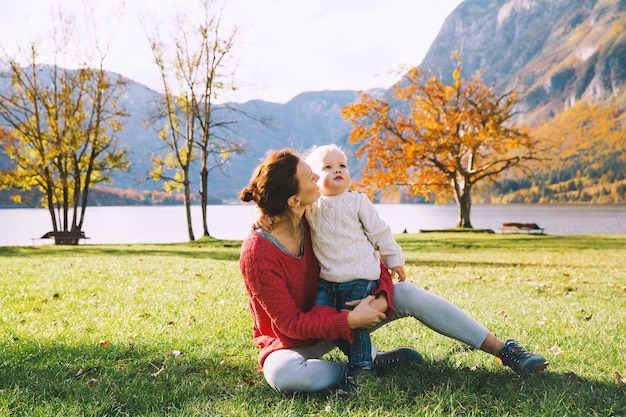 Mother and son walking outdoors Autumn on Lake Bohinj Slovenia Europe