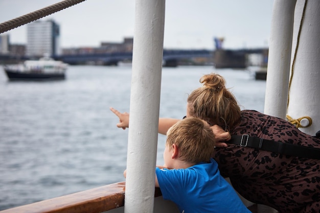 Mother and son watching the view from the shore in Aalborg