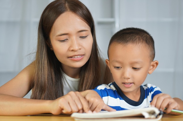 Mother teaching son to do homework