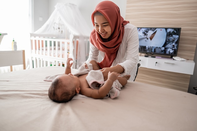 Mother wipe her baby boy with a towel