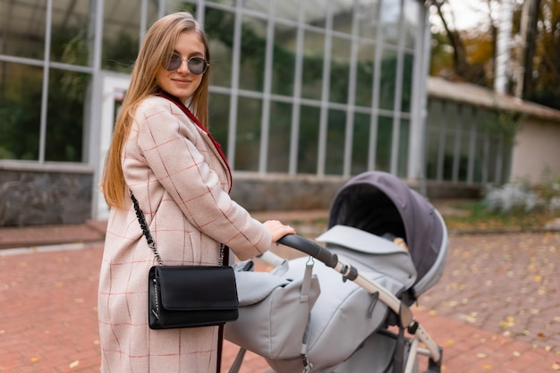 Mother with baby stroller for a walk