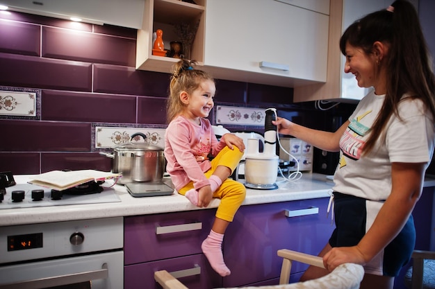 Mother with daughter cooking at kitchen happy children's moments