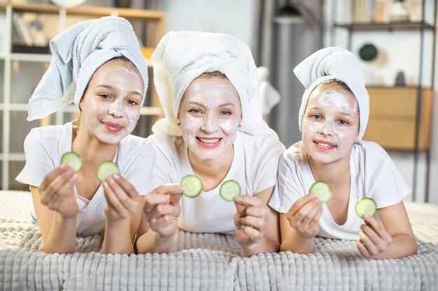 Mother with daughters doing vitamin mask for face skin